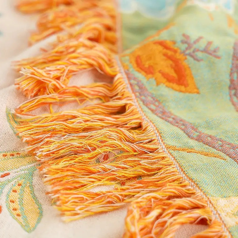 Close-up of tassel fringe on floral throw