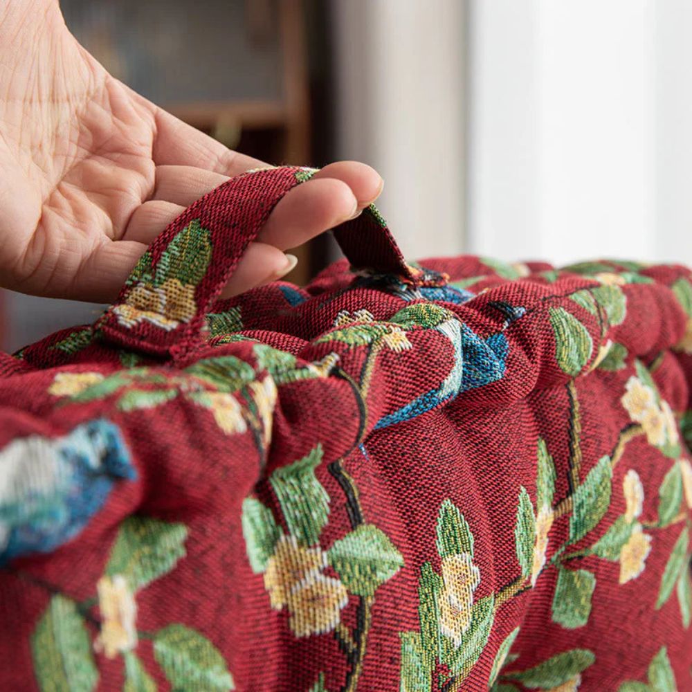Carry loop on the red tufted chair cushion
