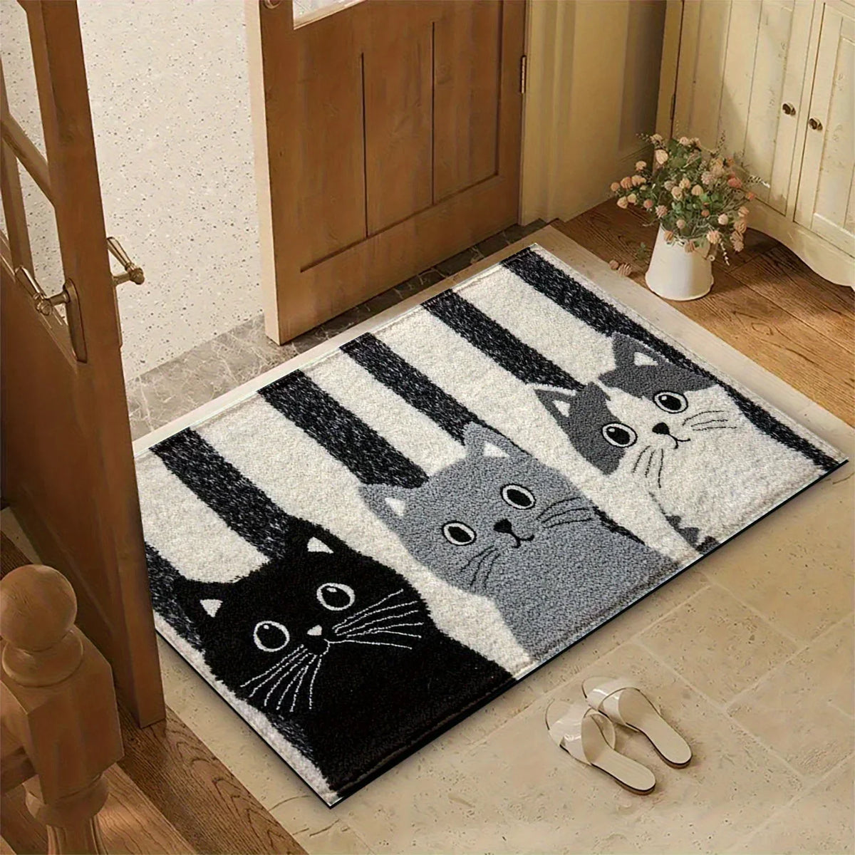 Black grey and white cat mat at an entrance