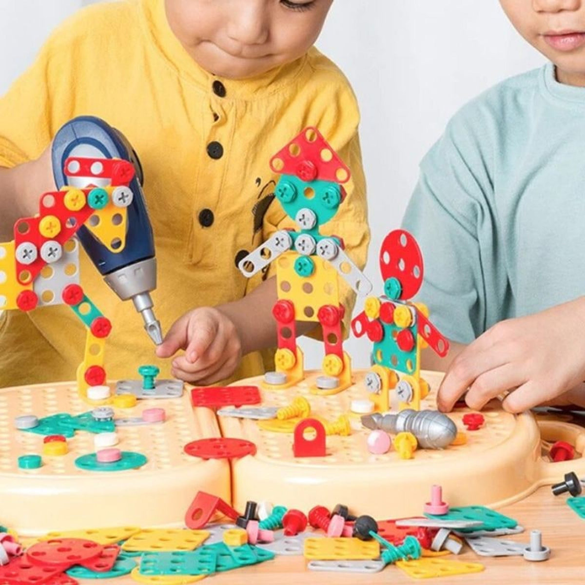 Children fastening coloured construction pieces into a board