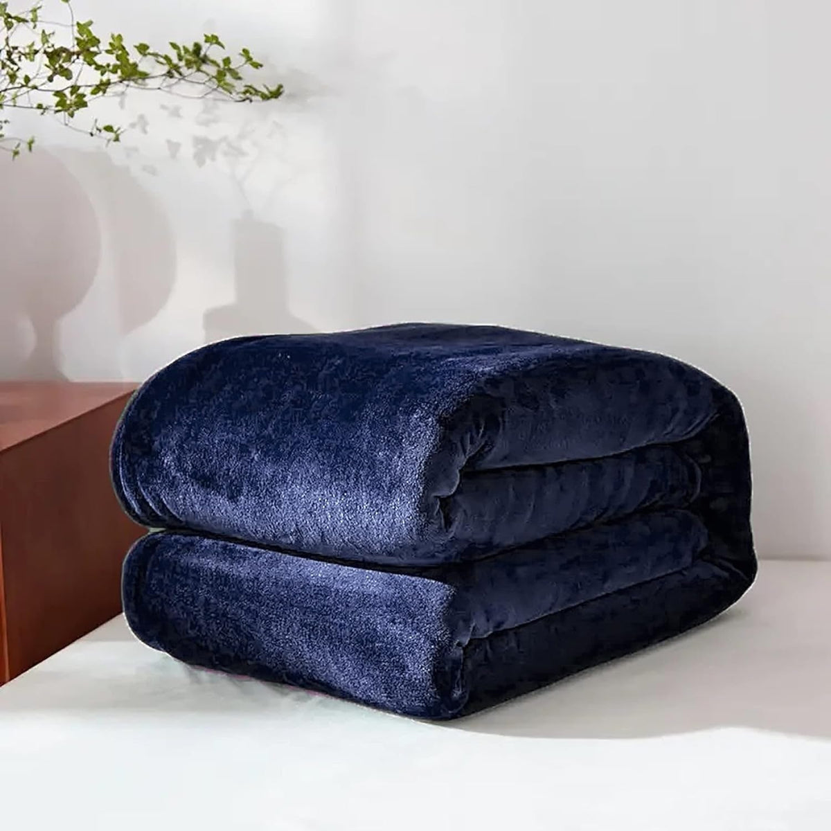 Navy blue fleece throw folded on a table
