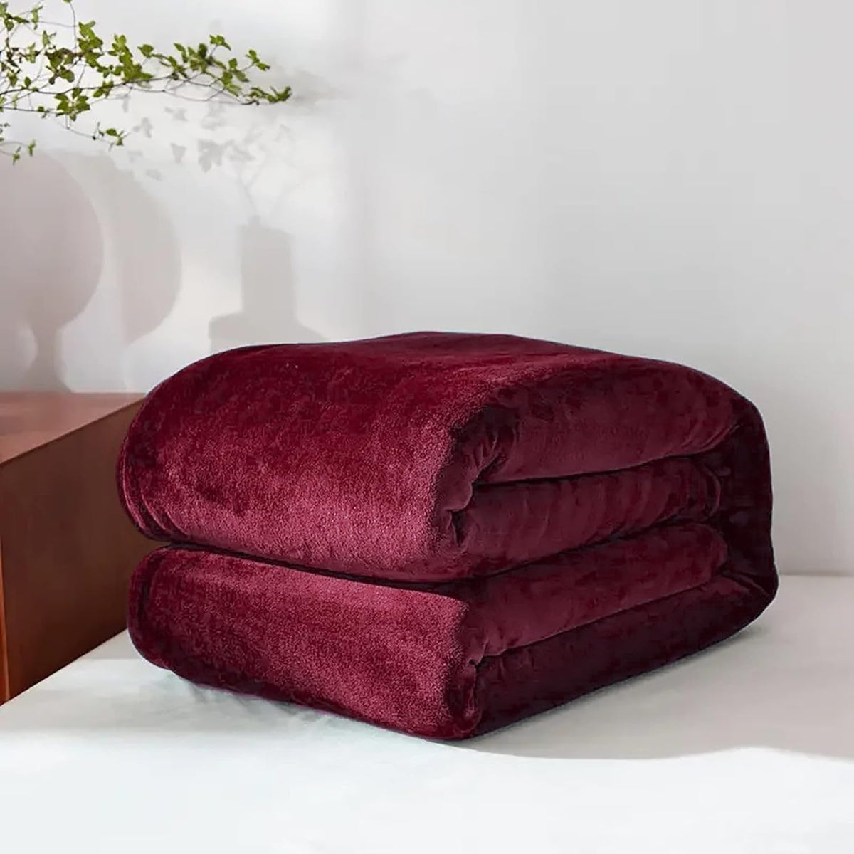 Burgundy fleece throw folded on a table