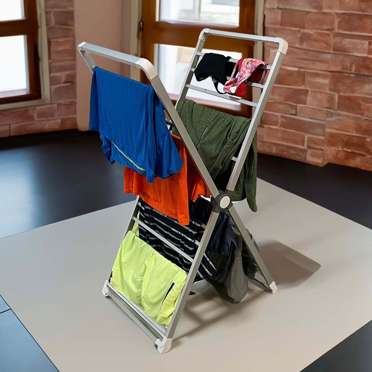 Tall X-frame clothes airer holding laundry