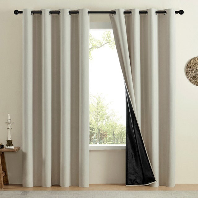 Beige eyelet curtain panels with dark lining