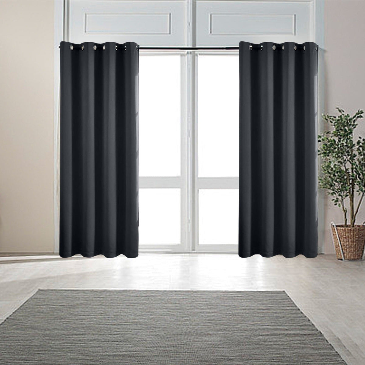 Black eyelet curtains at a window