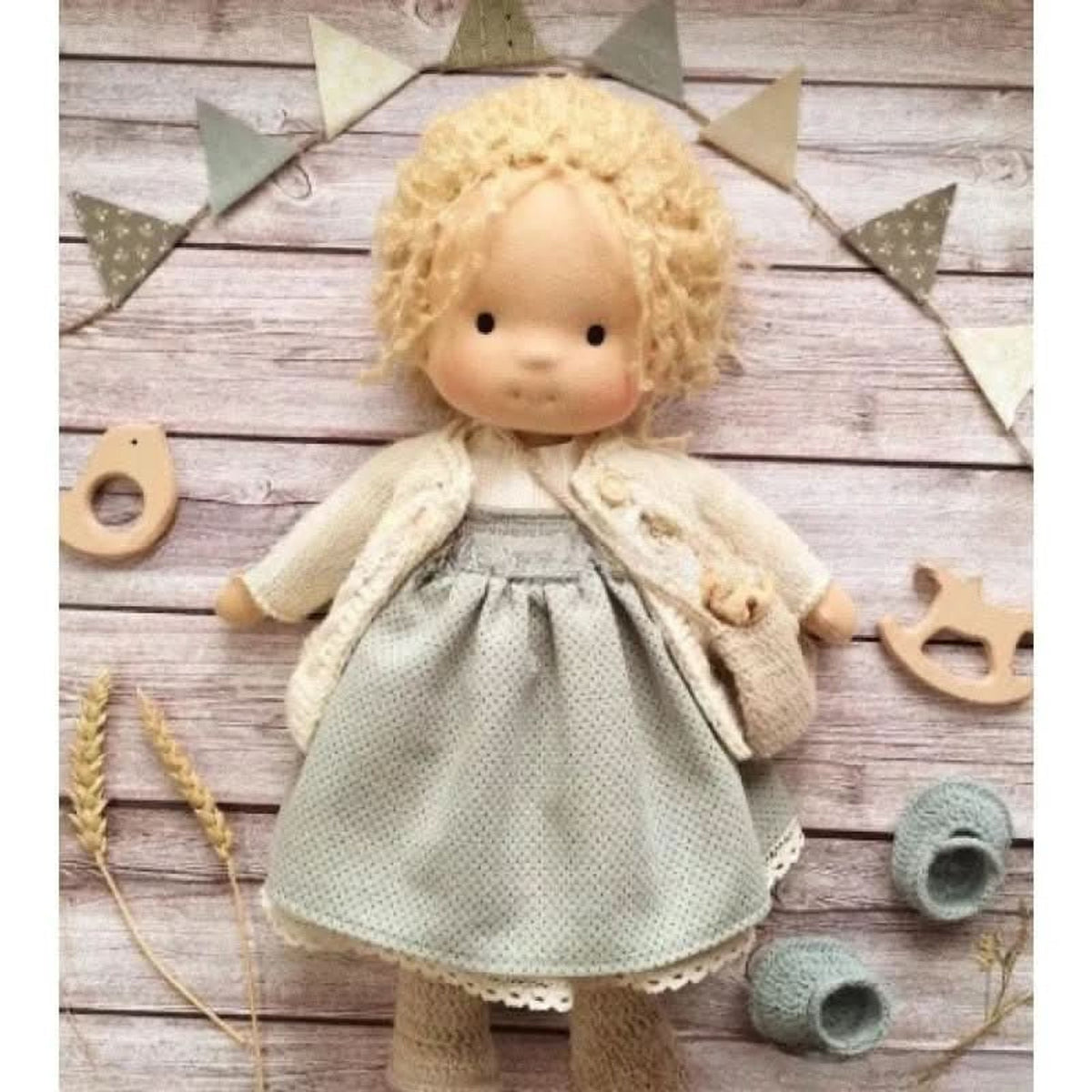 Blonde cloth doll in green-grey dress and cream cardigan