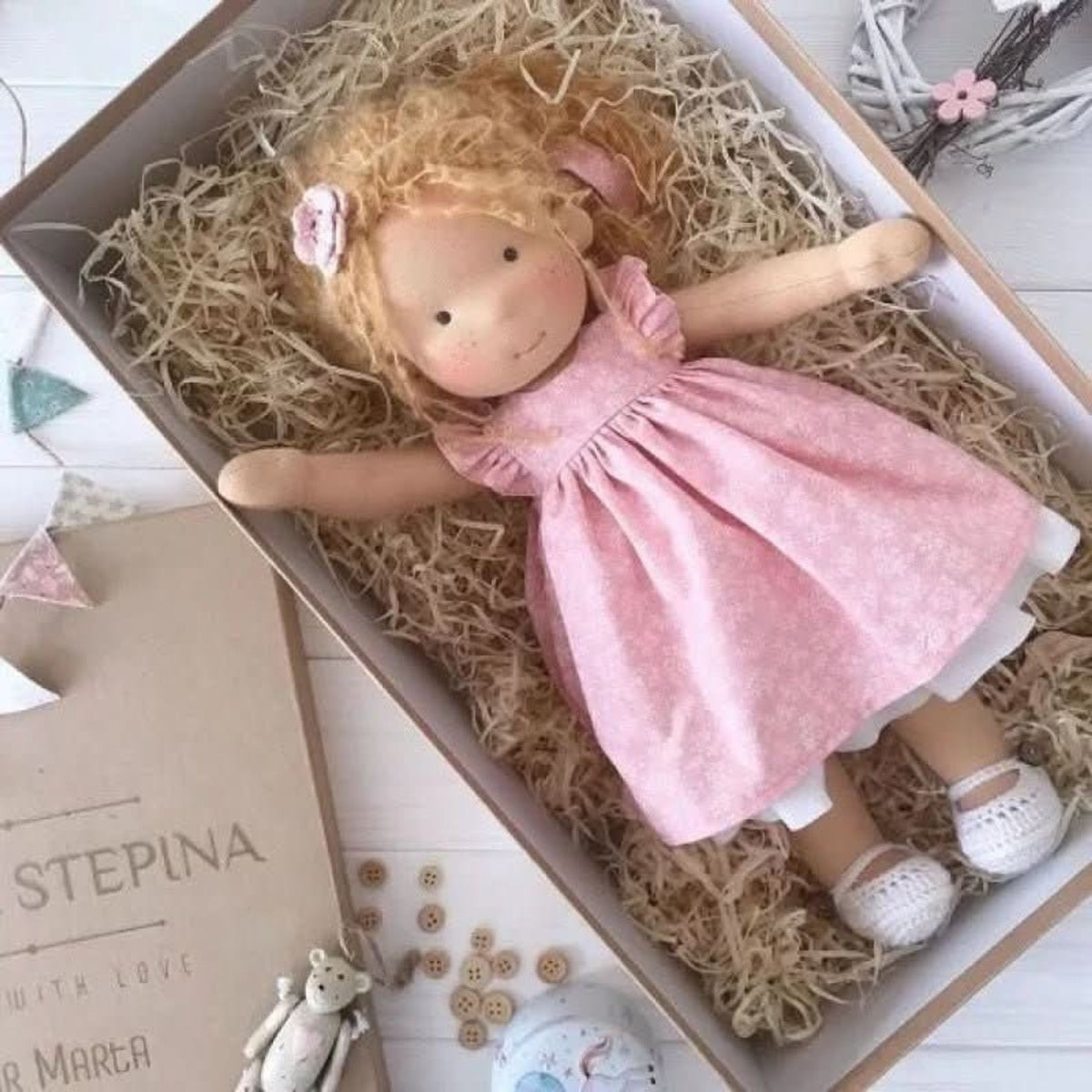 Blonde cloth doll in pink dress with white underlayer
