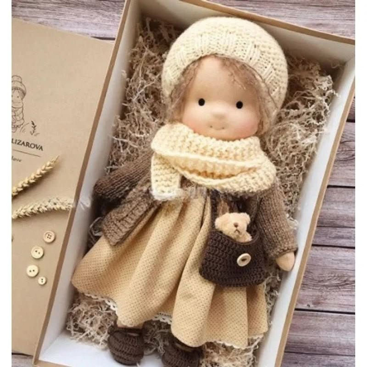 Blonde cloth doll in beige dress and brown cardigan