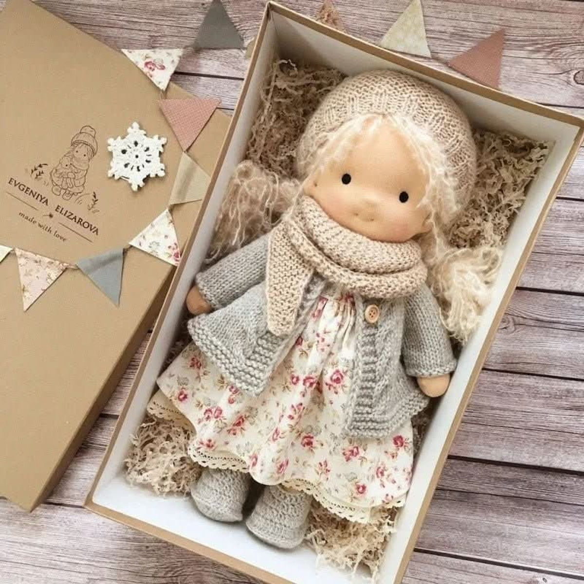 Blonde cloth doll in floral dress and grey cardigan