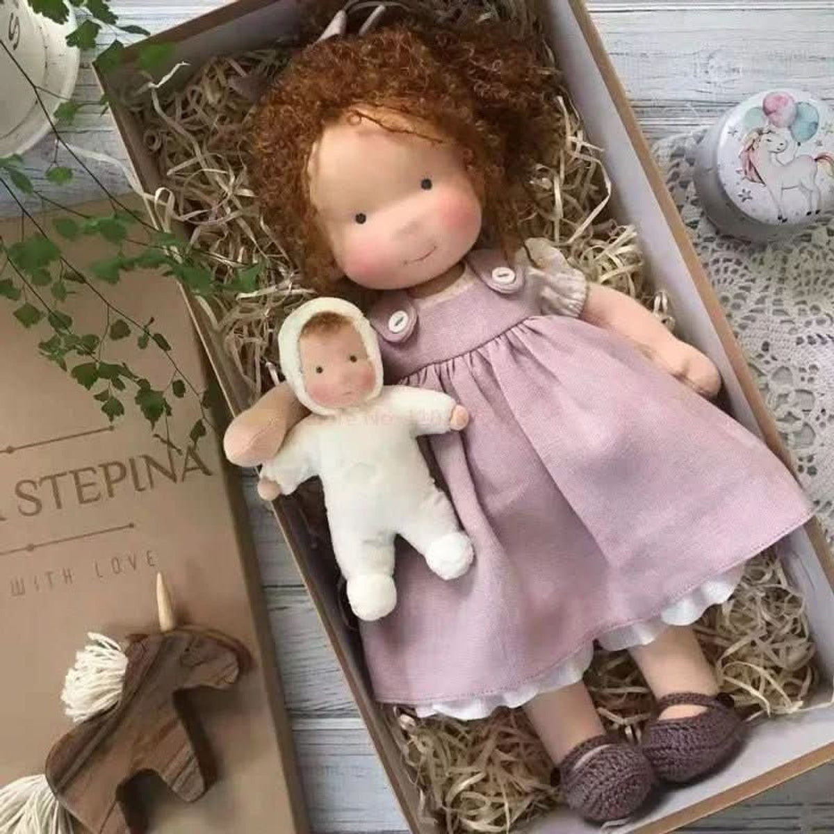 Curly auburn-haired cloth doll in lavender pinafore