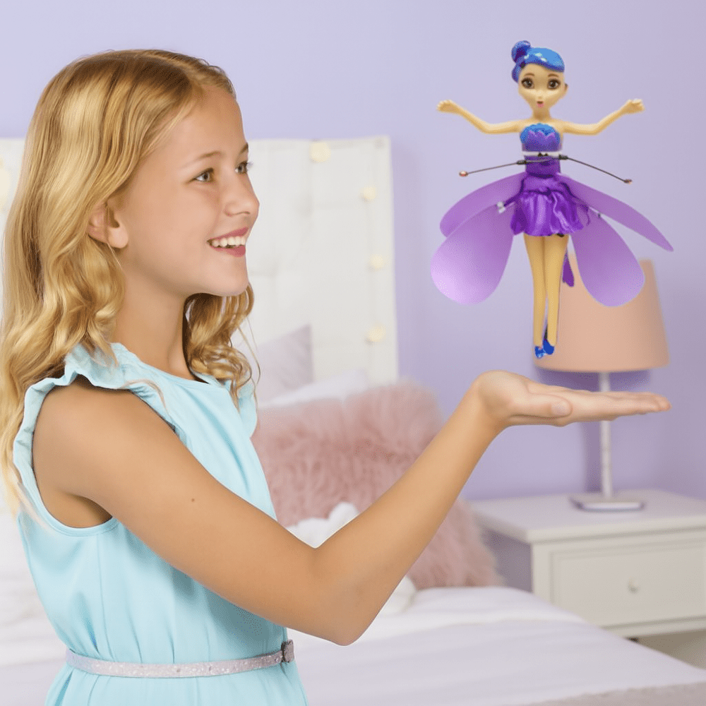 Purple fairy toy hovering over a child’s palm