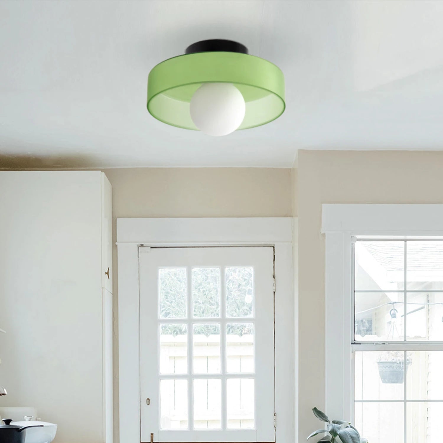 Minimalist modern flush mount ceiling light in olive green with a low-profile design for soft, diffused home lighting.