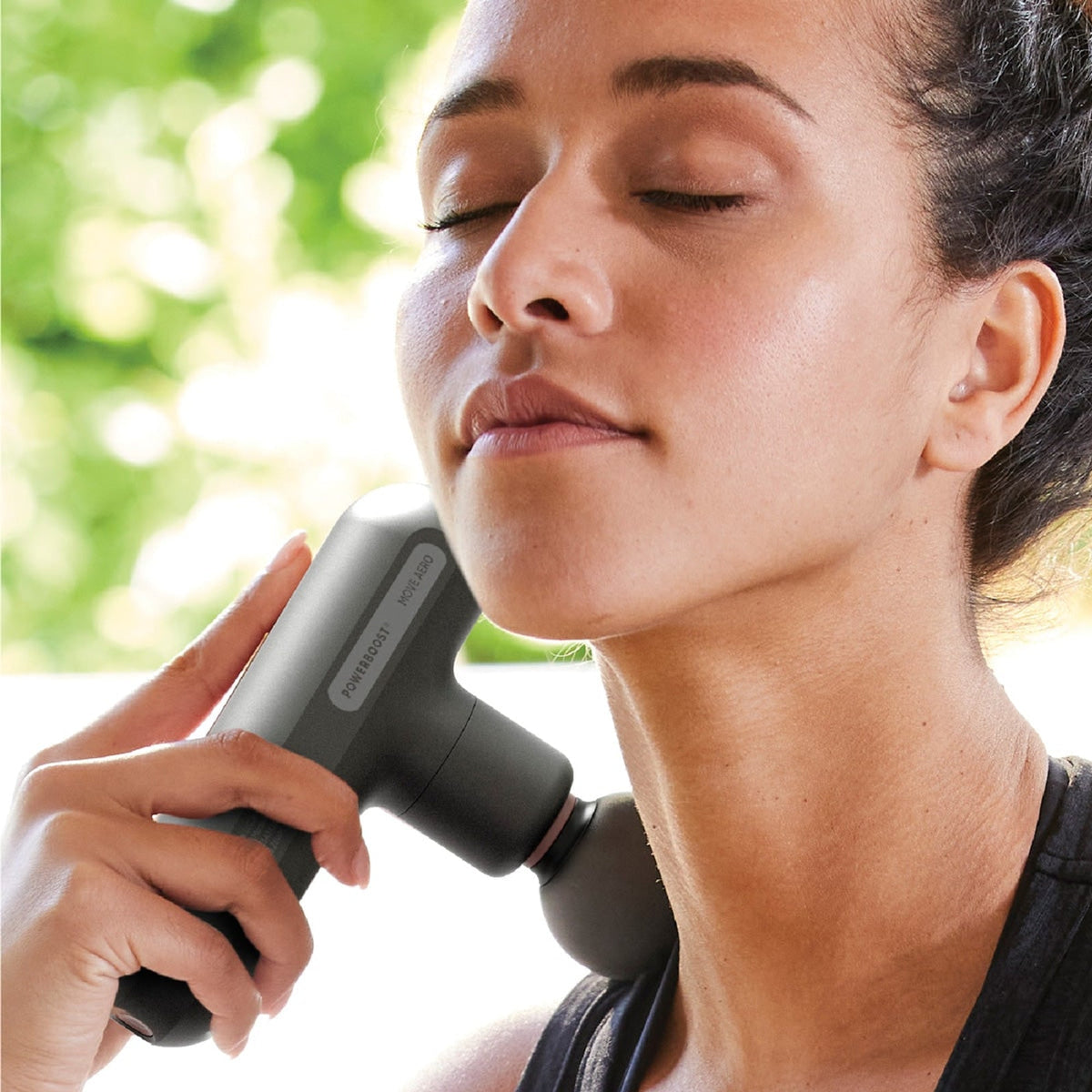 Powerboost Move Aero massage gun shown in use