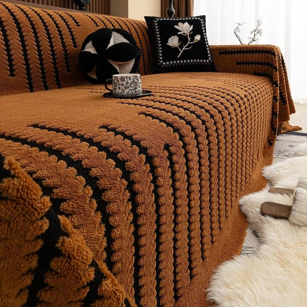 Amber tufted sofa blanket with black stripe detailing