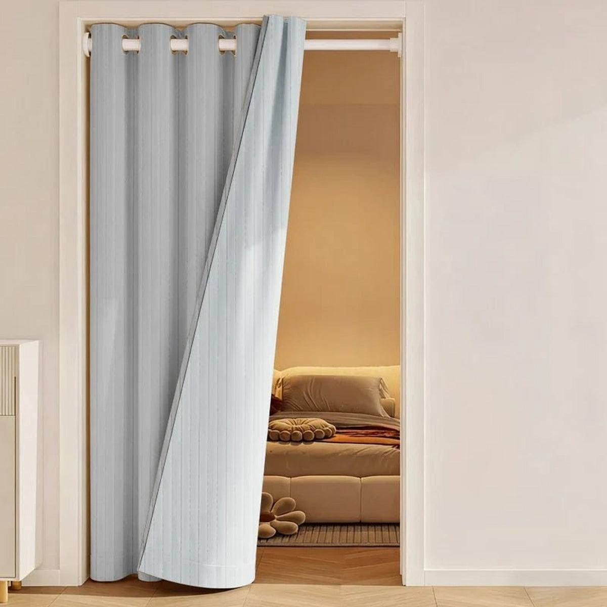 Grey eyelet curtain drawn to the side