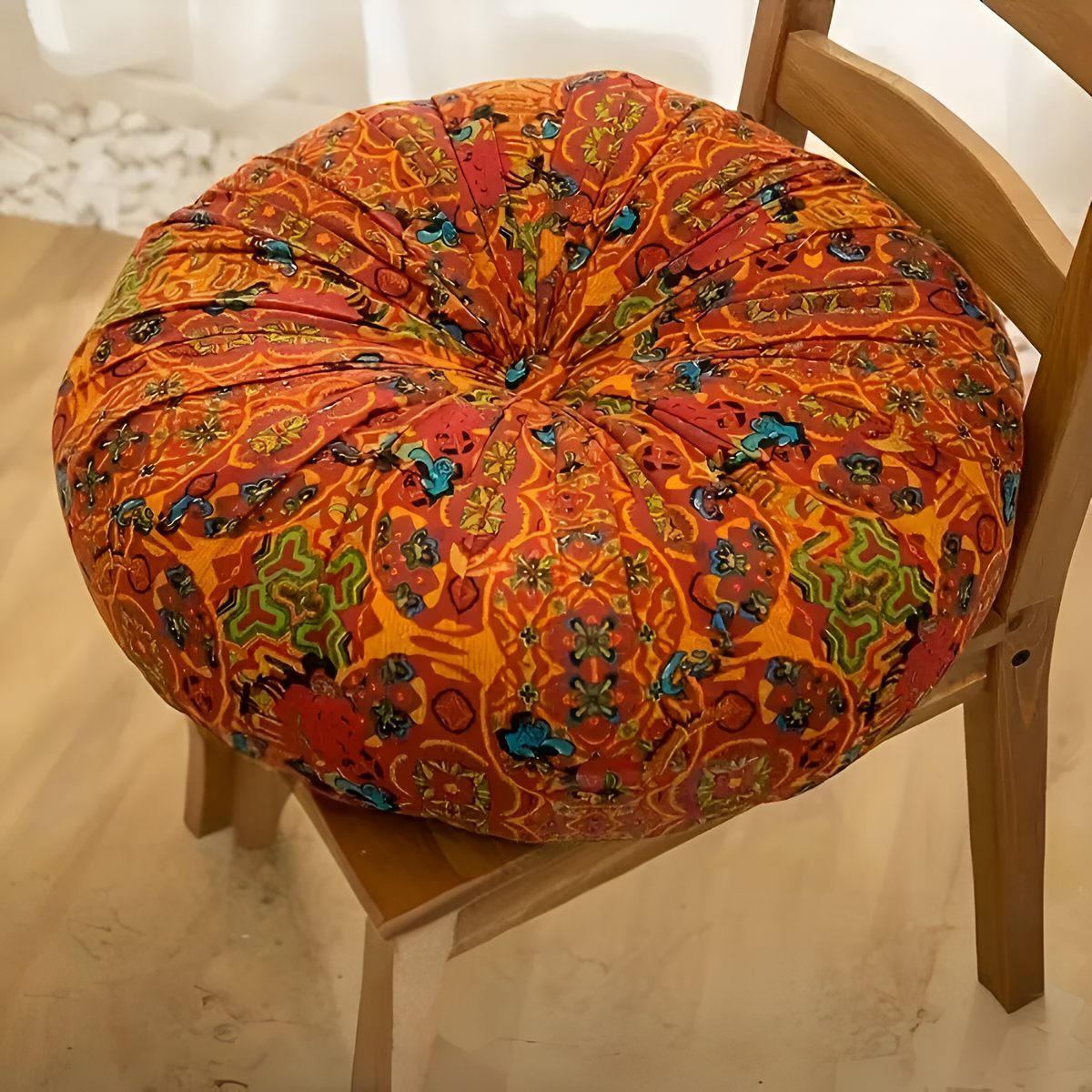 Orange round geometric cushion on a chair