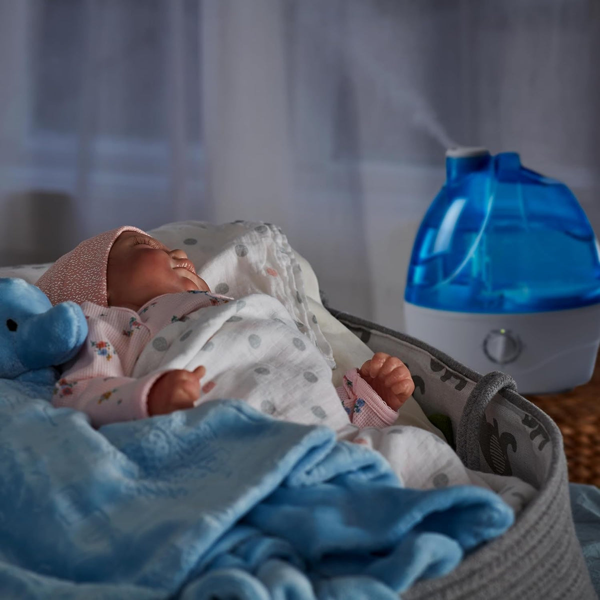 Cool mist humidifier beside a sleeping baby