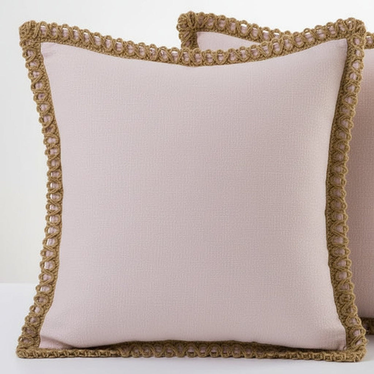 Nude pink cushions with decorative trim