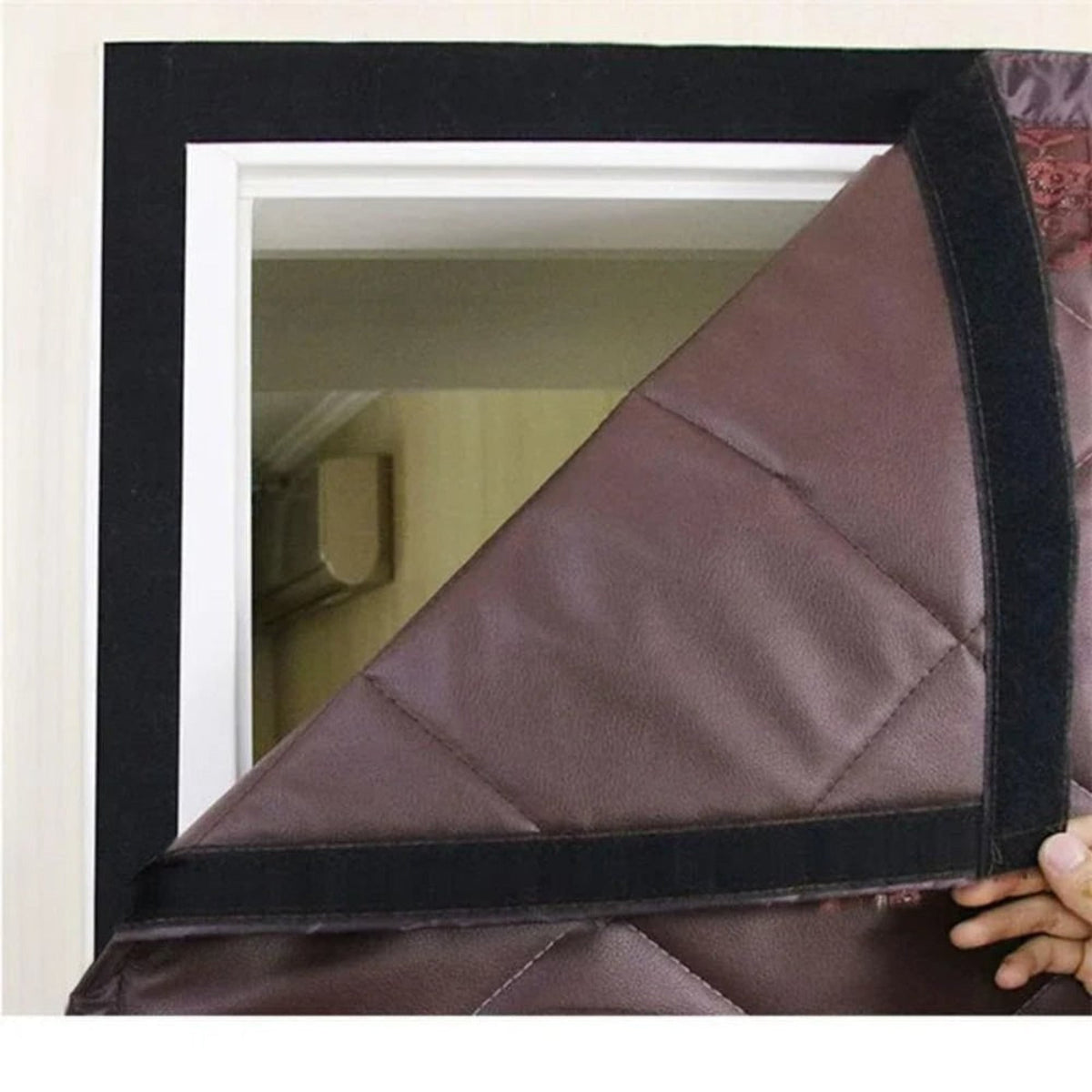 Brown curtain corner lifted to show lining