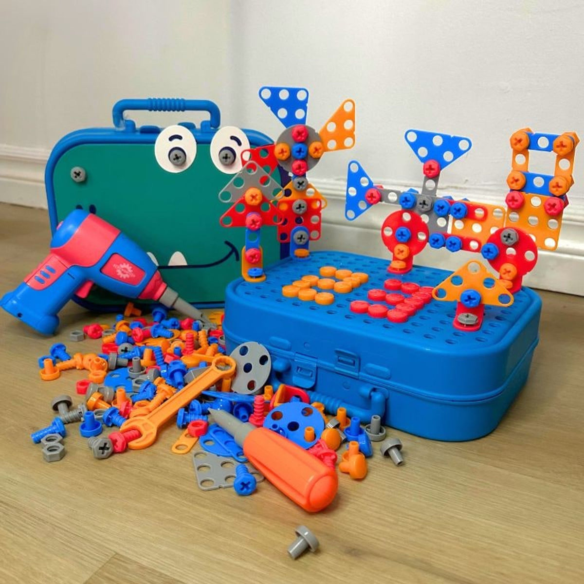 Construction case with assembled dinosaur and geometric models