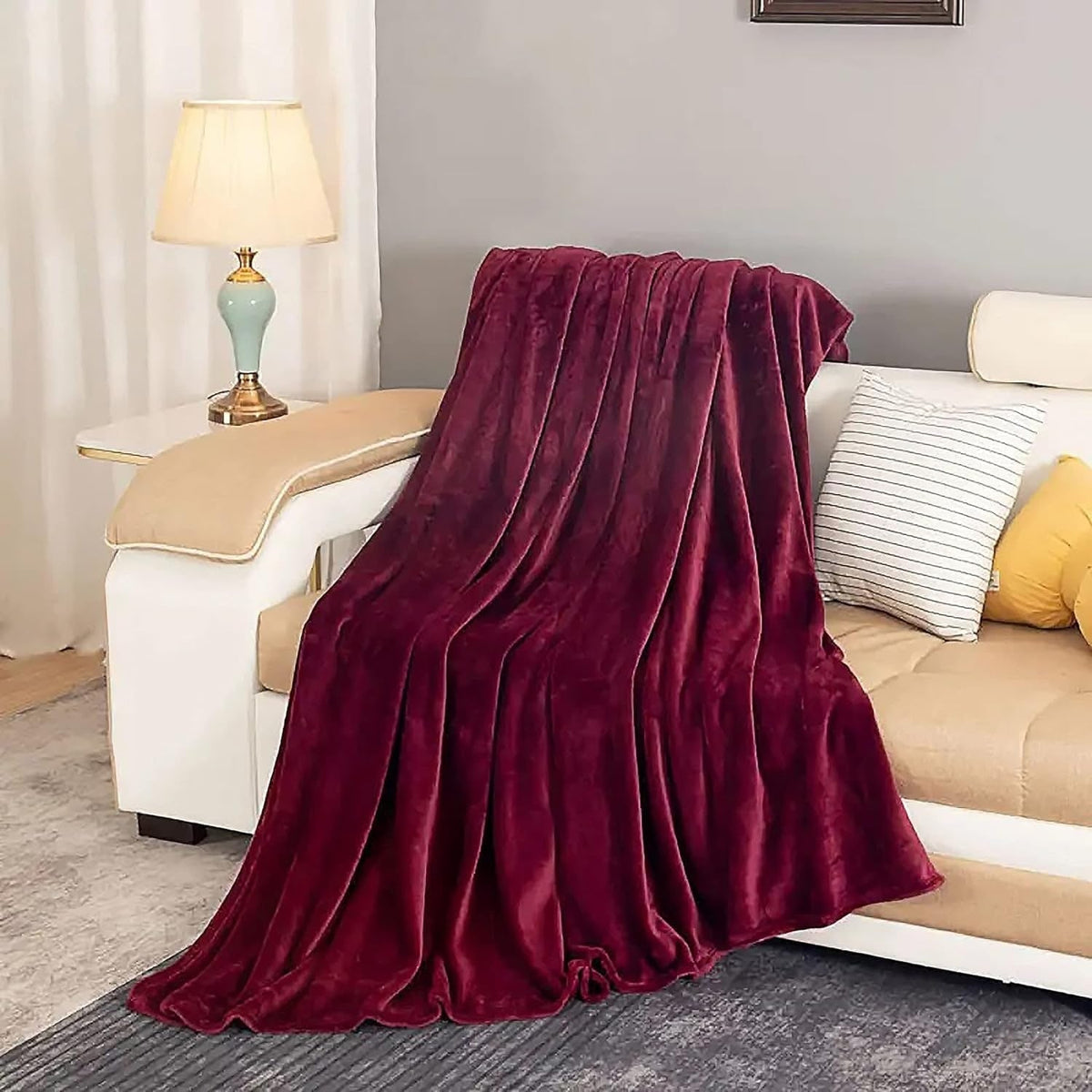 Burgundy fleece throw draped over a sofa