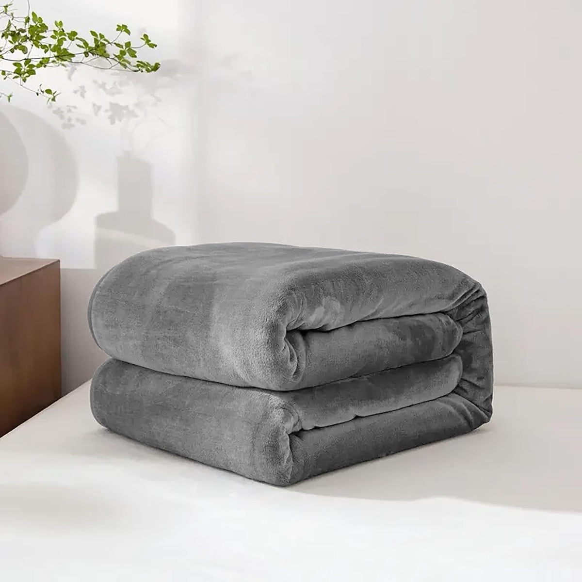 Grey faux fur fleece throw folded on a table