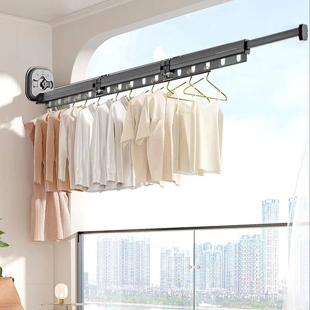 Grey three-fold suction-mounted drying rack on a window
