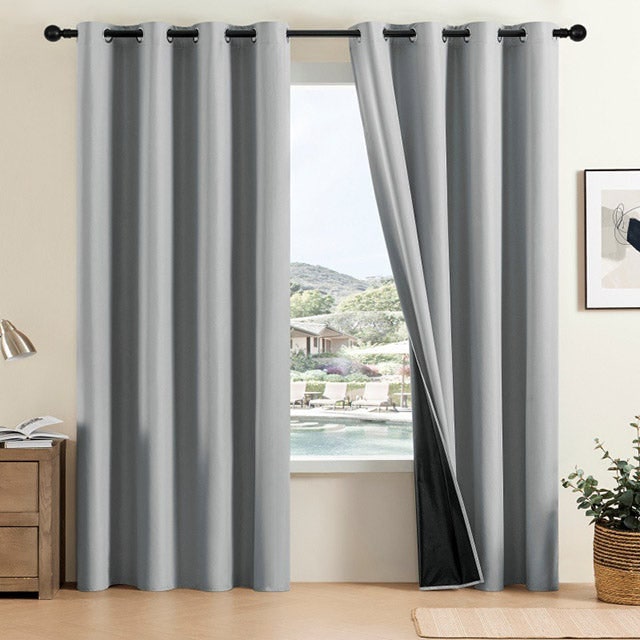 Grey eyelet curtain panels with dark lining