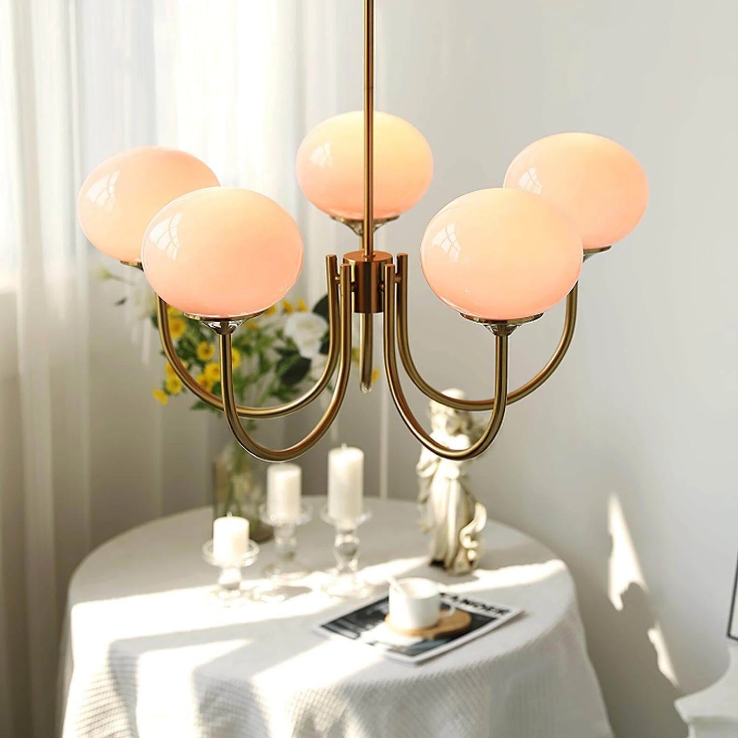 Modern glass ball pendant light with metal finish, suitable for living room or bedroom ceiling lighting.