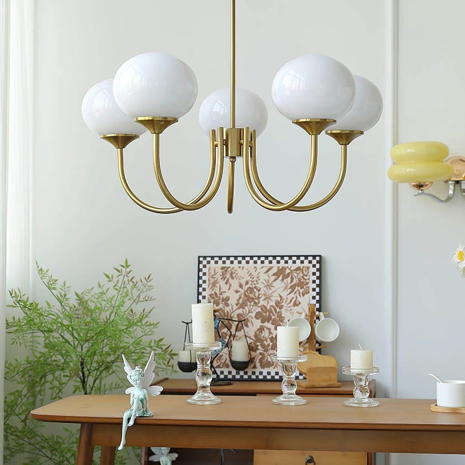 Modern glass ball pendant light with metal finish, suitable for contemporary dining rooms and bedrooms.
