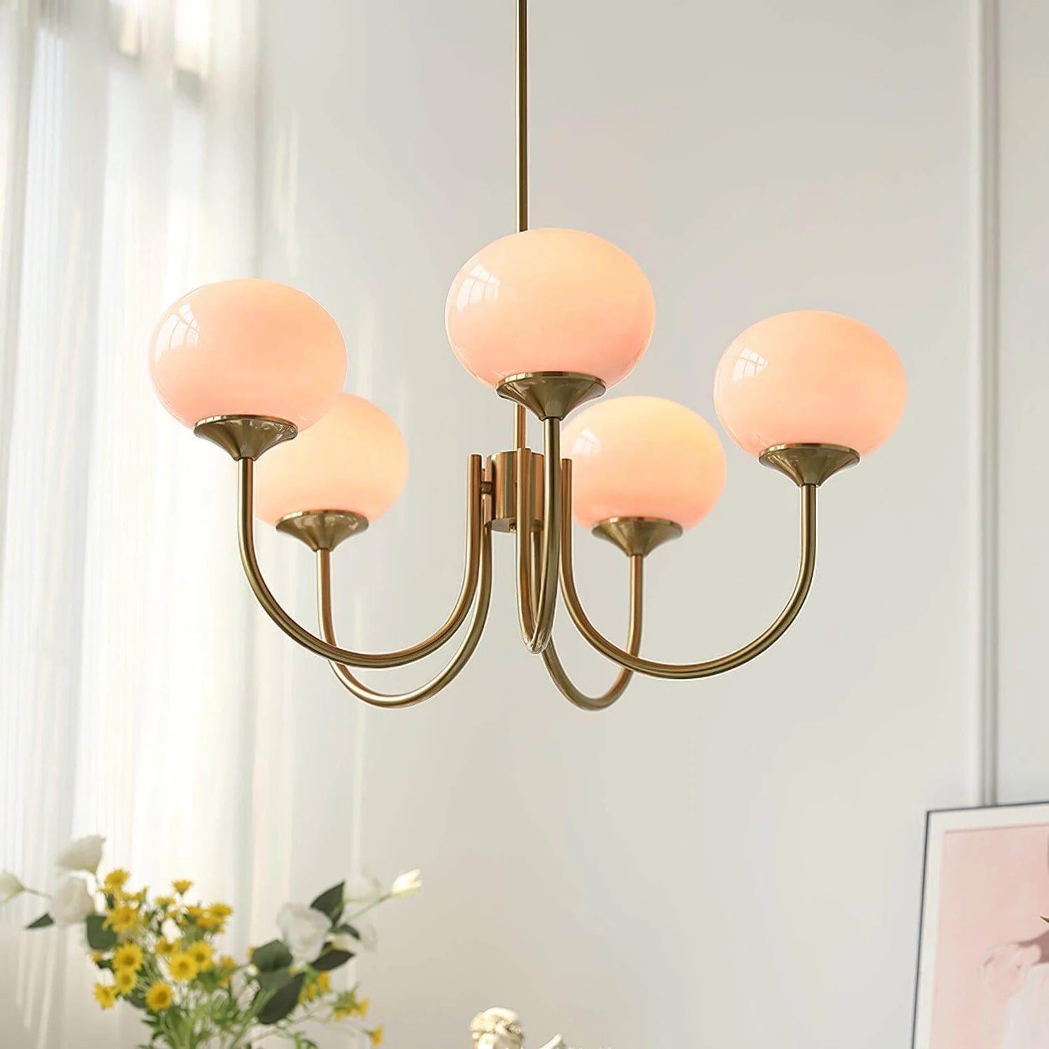 Modern glass ball pendant light with metal finish, suitable for contemporary dining rooms and bedrooms.