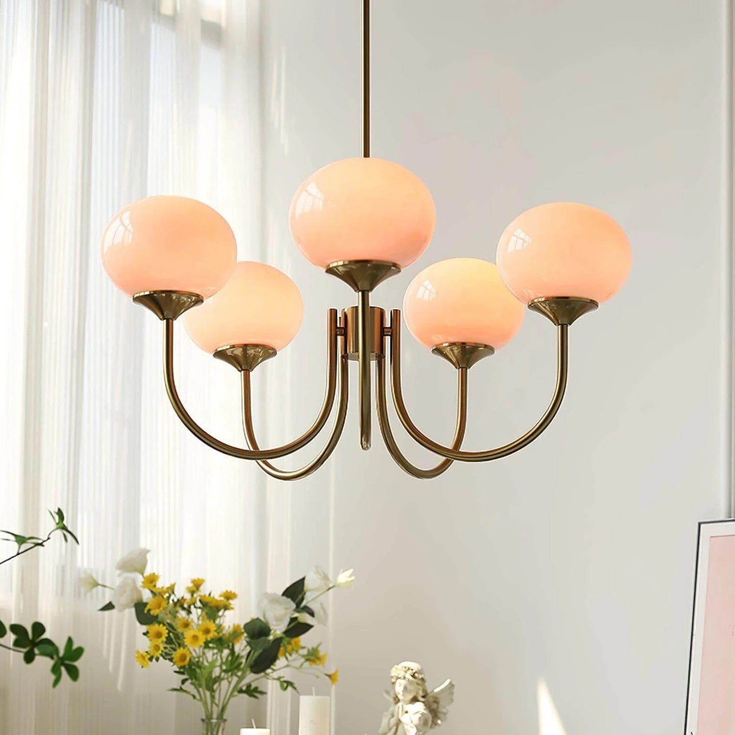 Modern glass ball pendant light with metal finish, suitable for living room or bedroom ceiling lighting.