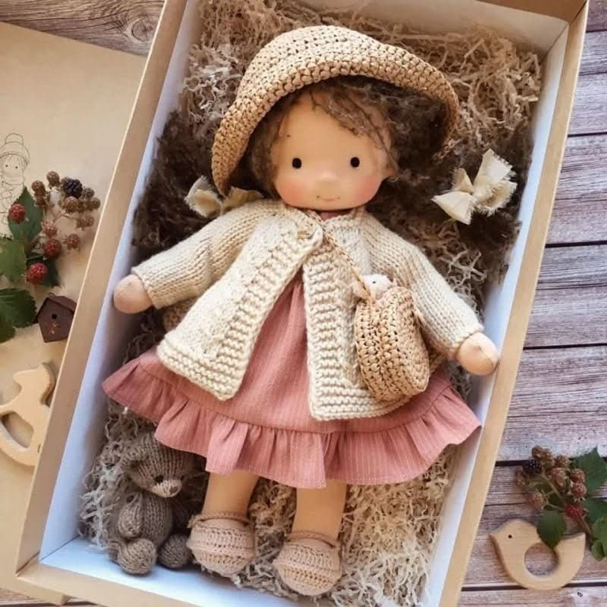 Brunette cloth doll in pink dress and straw hat