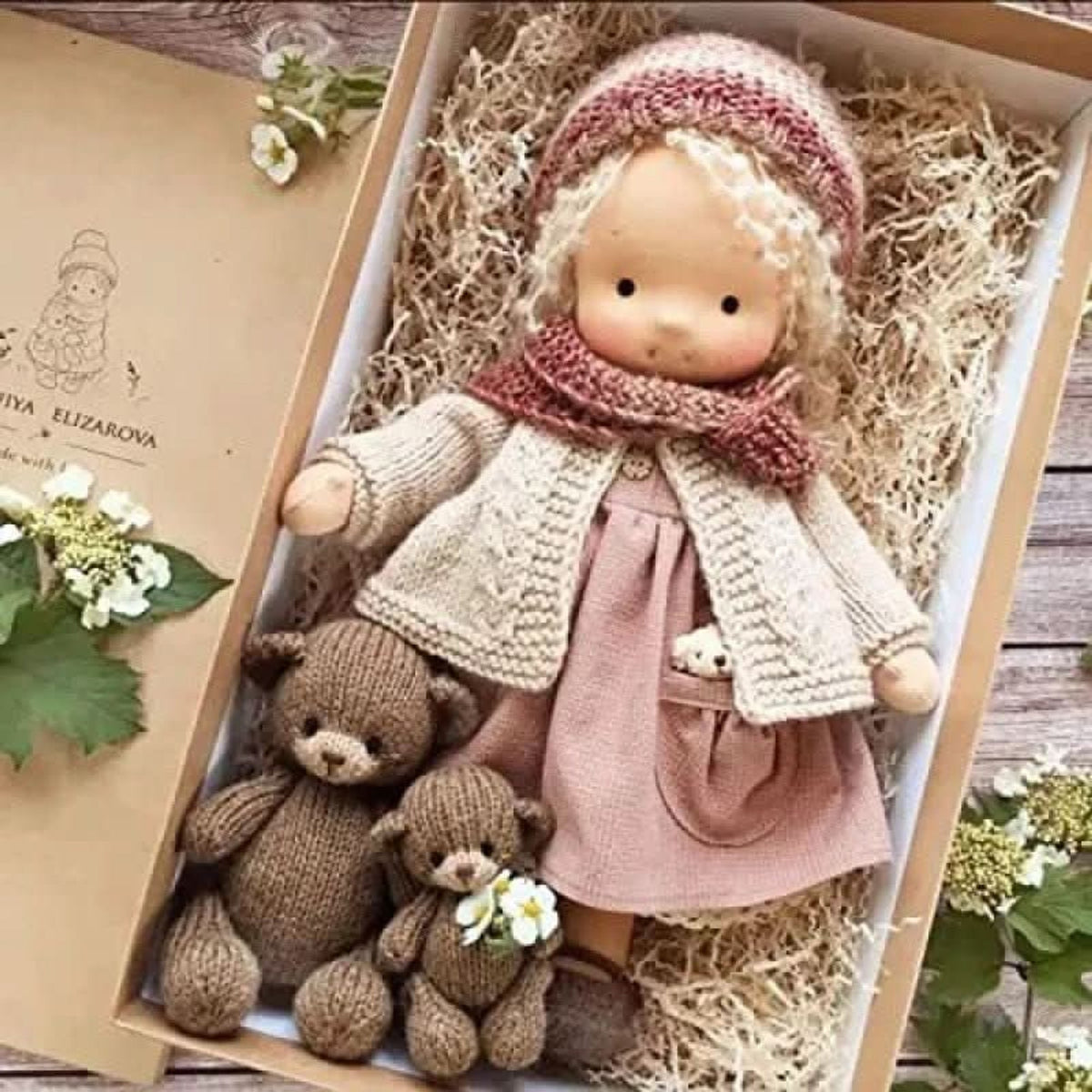 Blonde cloth doll in pink hat, scarf and dress