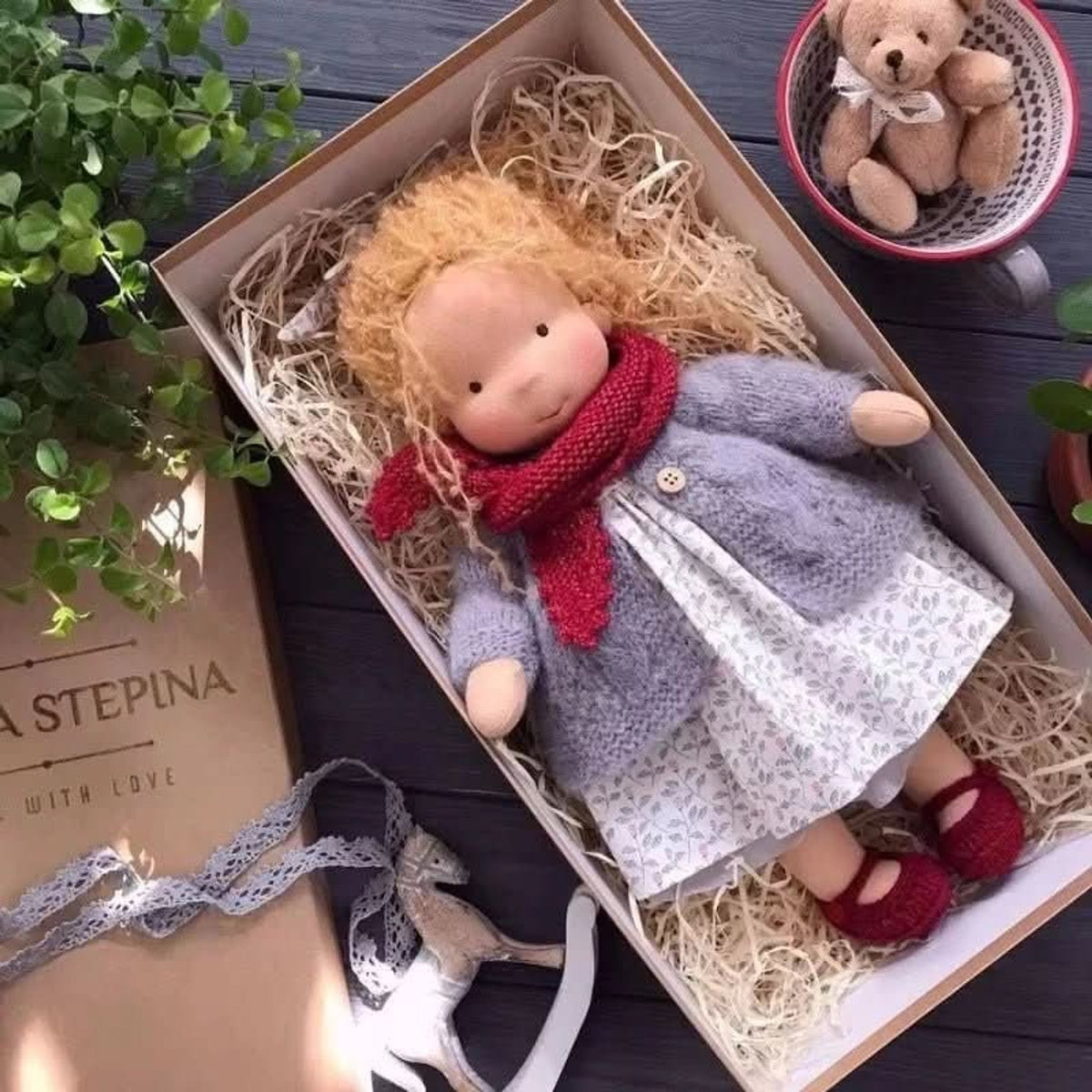Blonde cloth doll in grey cardigan and red scarf
