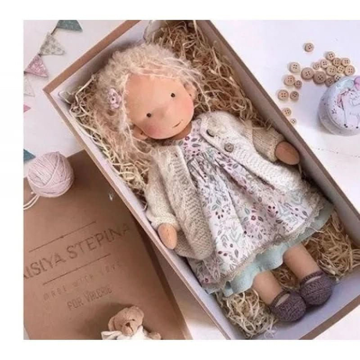 Blonde cloth doll in floral dress and cream cardigan