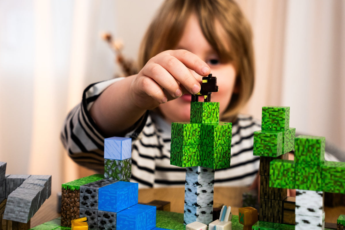 Child stacking patterned magnetic building cubes