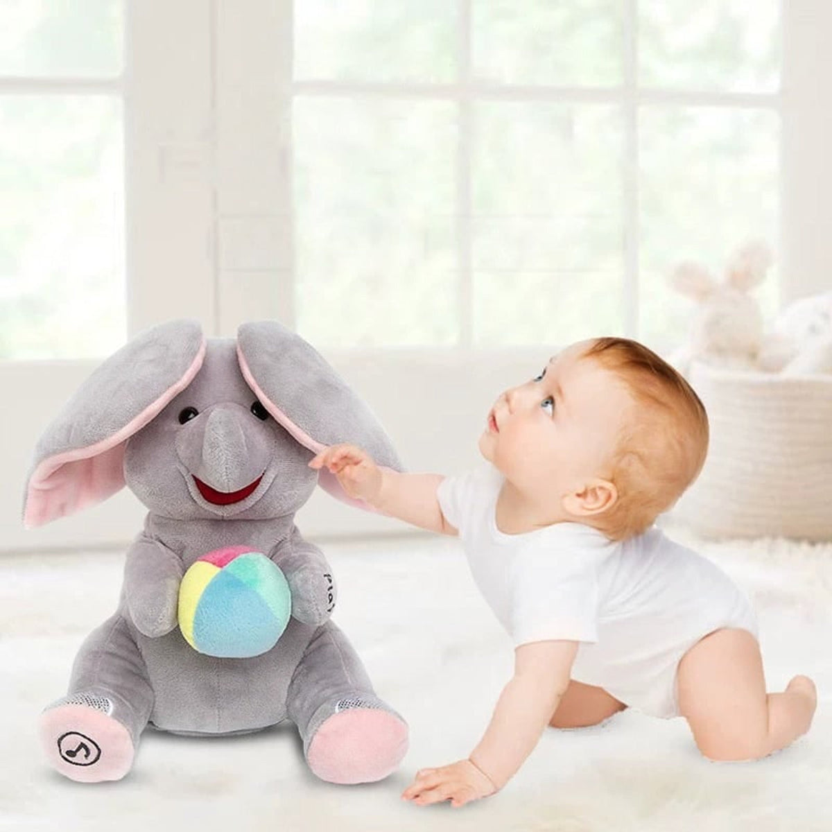 Grey musical elephant with pink ears beside a baby