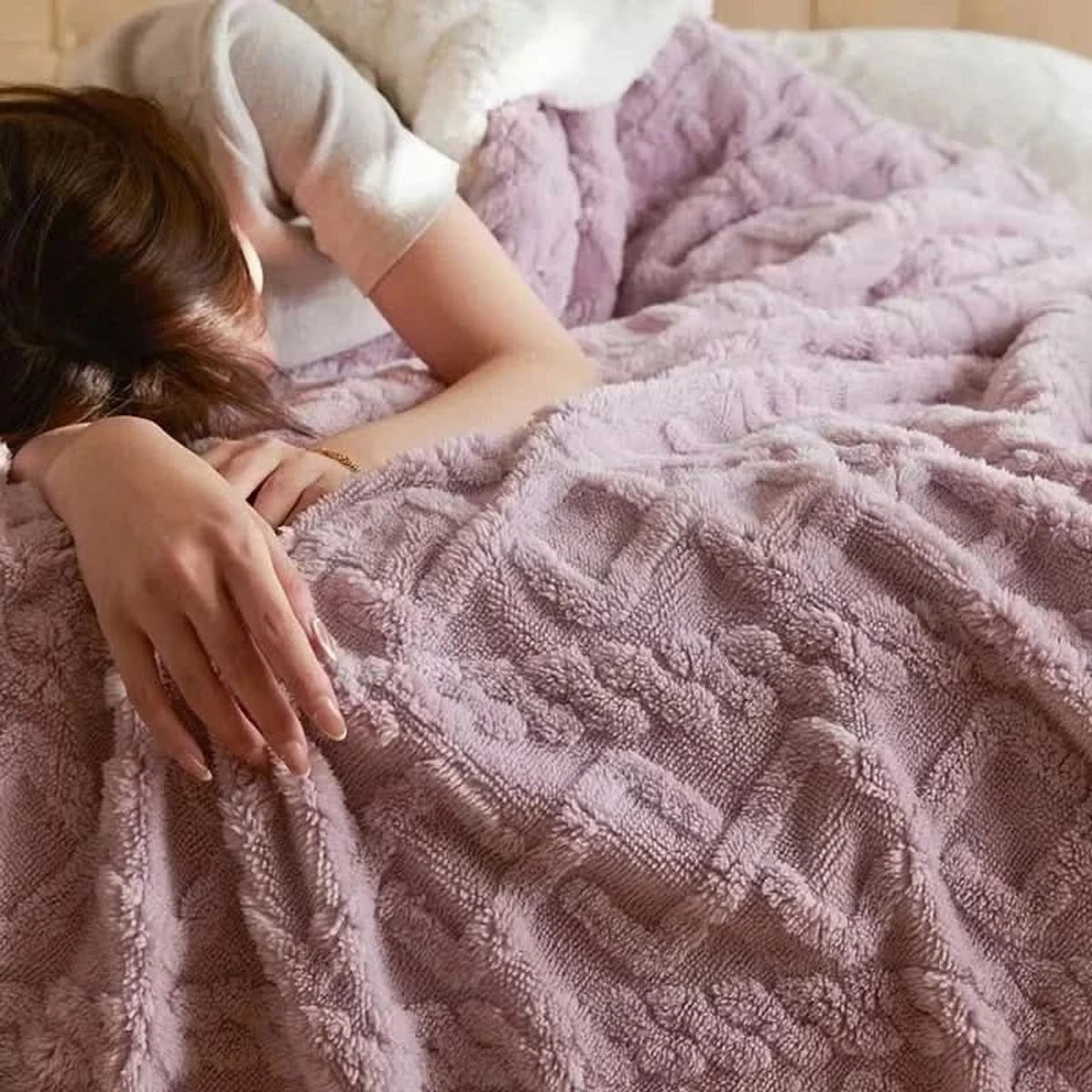 Close-up of raised floral texture on pink blanket