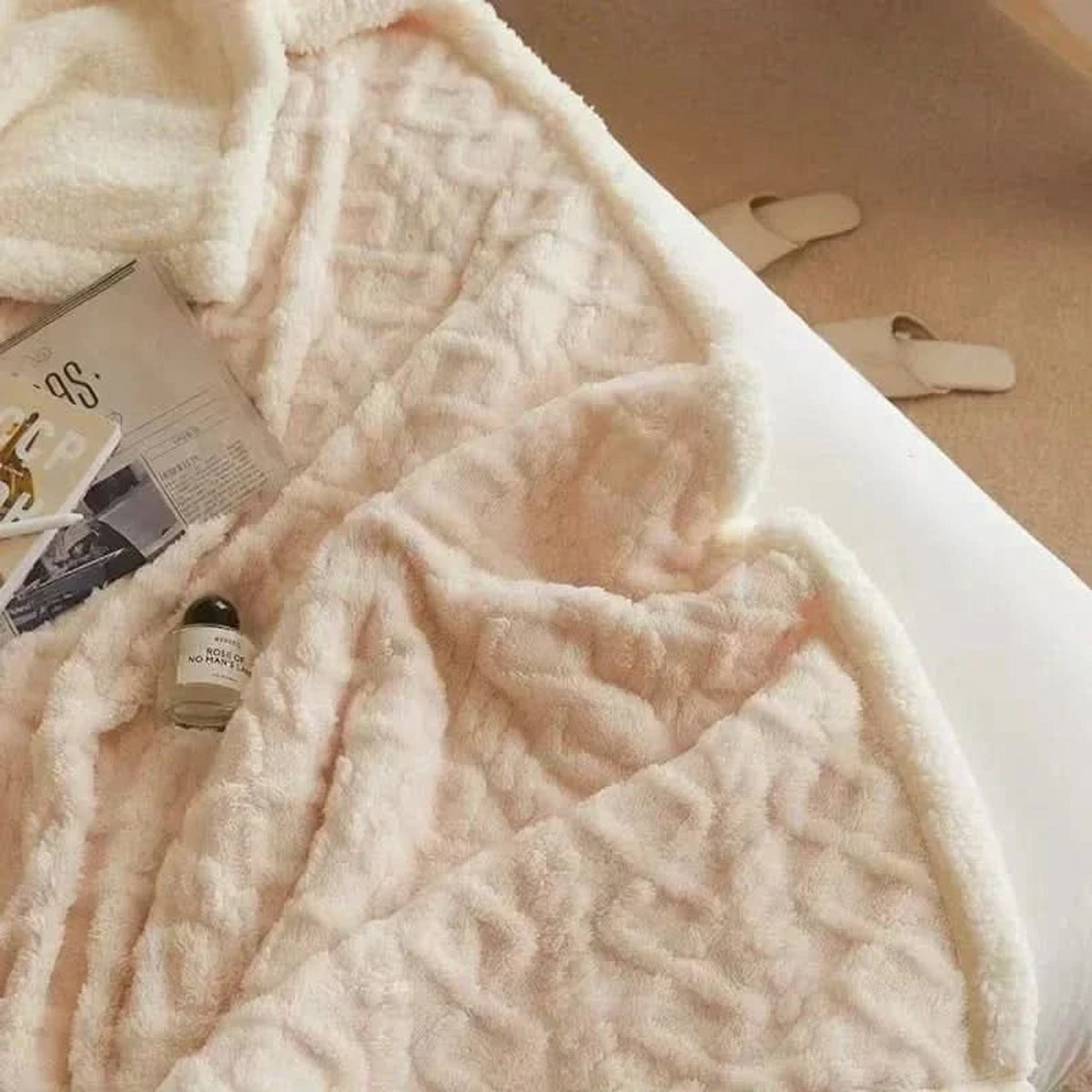Pale white blanket with raised floral texture