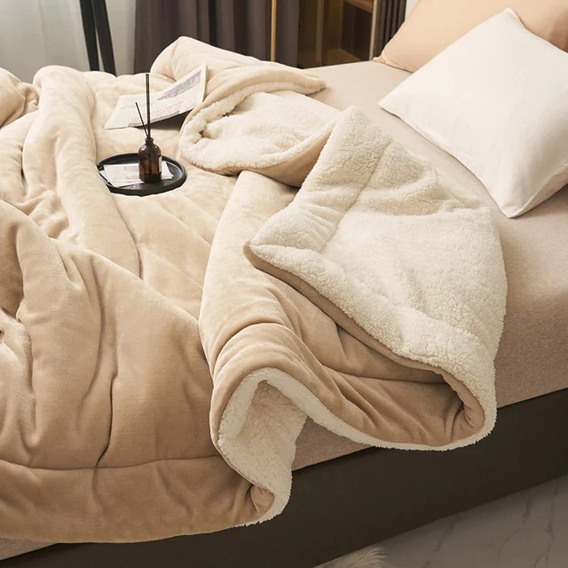 Beige fleece blanket folded back to show sherpa lining