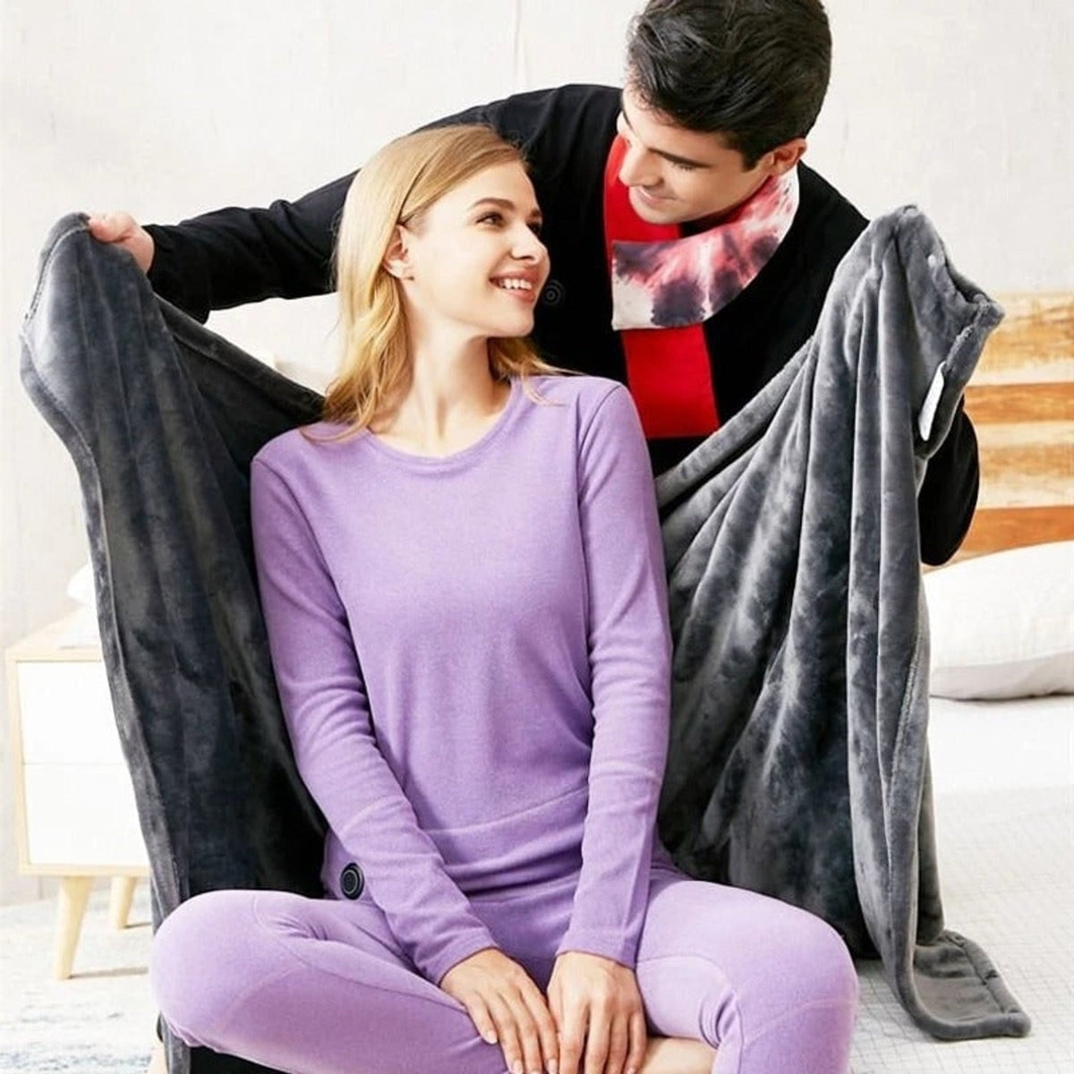 Grey fleece wrap being placed around the shoulders